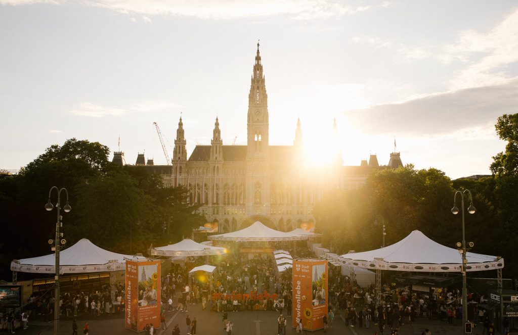 Studio Wey Frontale Ansicht auf das Wiener Rathaus während dem Wienliebe Festival bei Sonnenuntergang